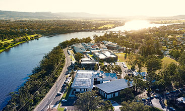 Aerial view of Shoalhaven hospital looking west with the sun setting over the Shoalhaven River 