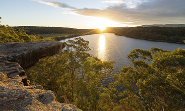 Sun setting over hanging rock at Shoalhaven River, NSW.