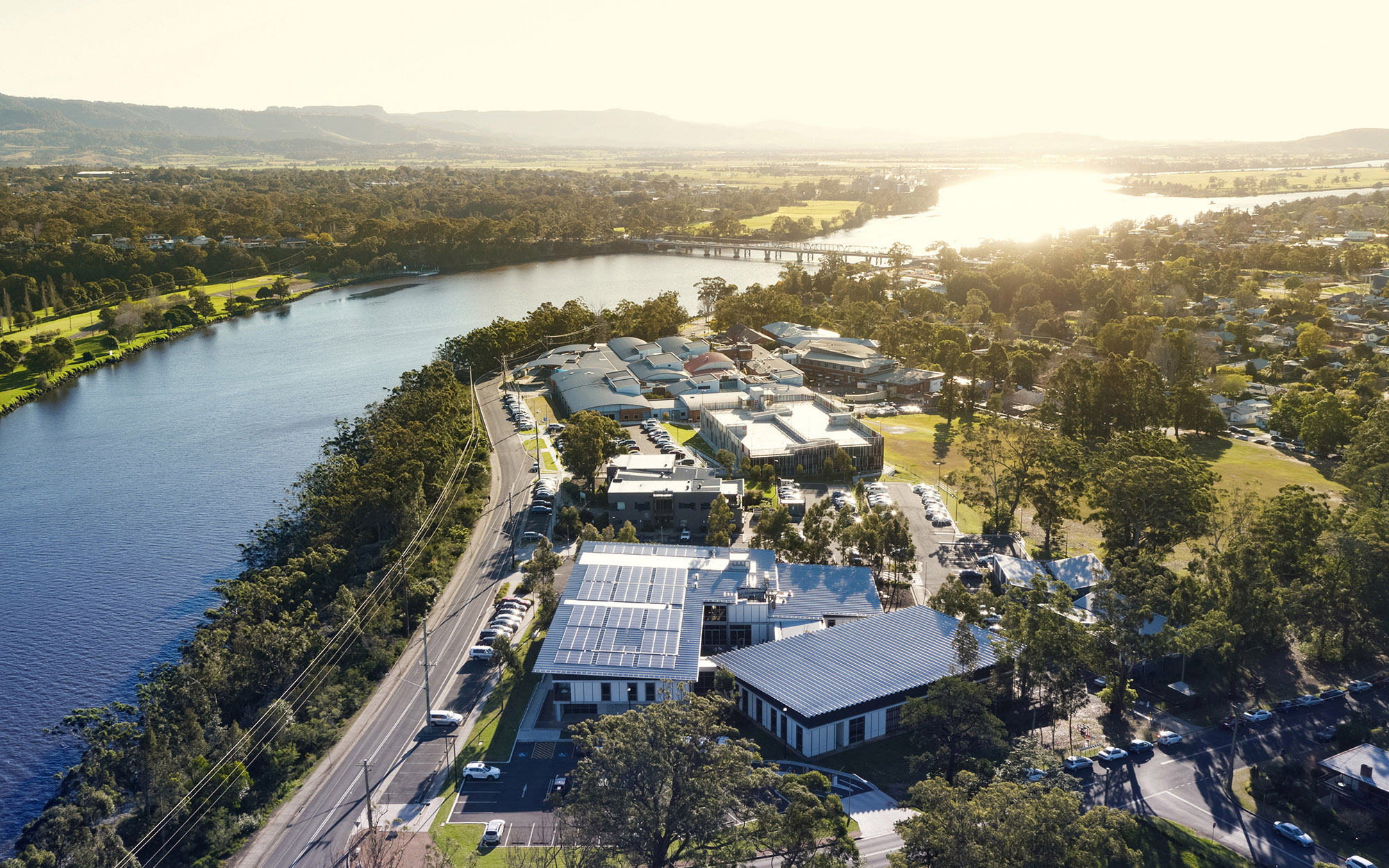 Aerial view of Shoalhaven hospital looking west with the sun setting over the Shoalhaven River 